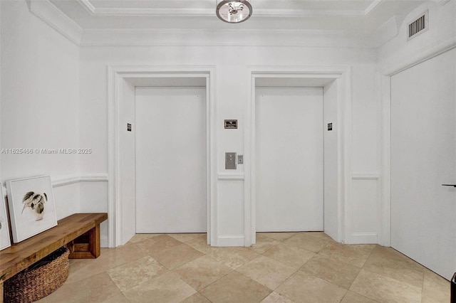 interior space with elevator, visible vents, and ornamental molding