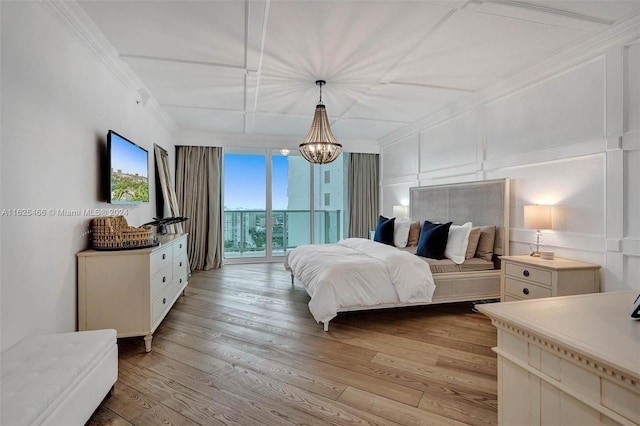 bedroom featuring ornamental molding, a notable chandelier, access to exterior, and light wood-type flooring