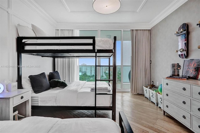 bedroom featuring light wood-style flooring and ornamental molding