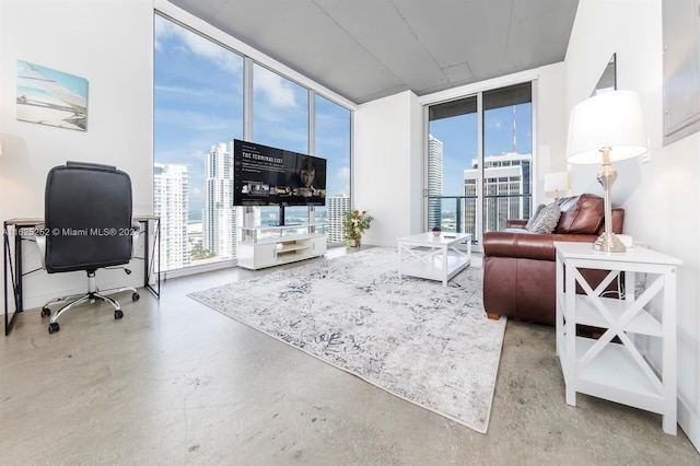 living room featuring a wall of windows and concrete flooring