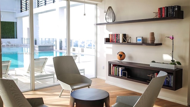 living area featuring hardwood / wood-style flooring and a wealth of natural light