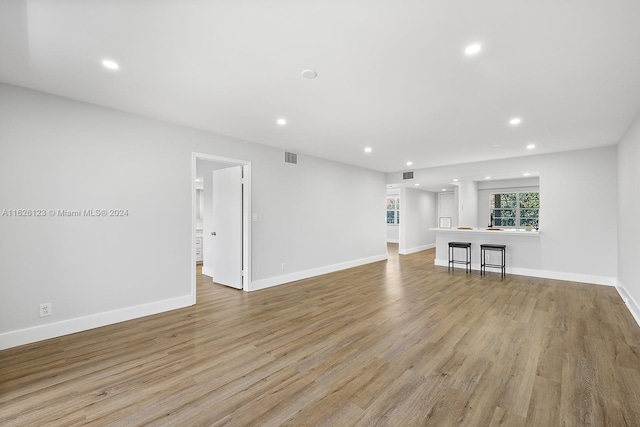 unfurnished living room with light hardwood / wood-style flooring