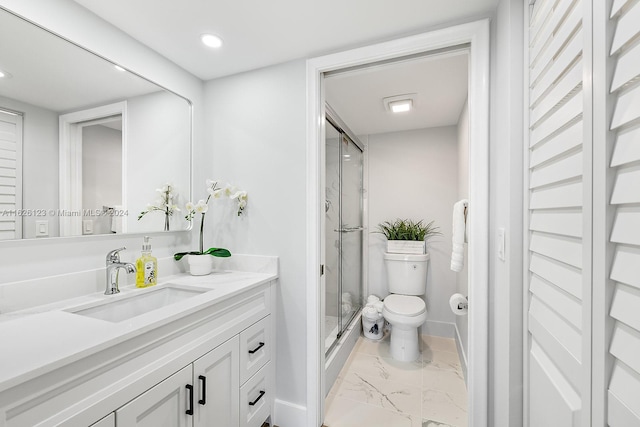 bathroom featuring vanity, toilet, and an enclosed shower