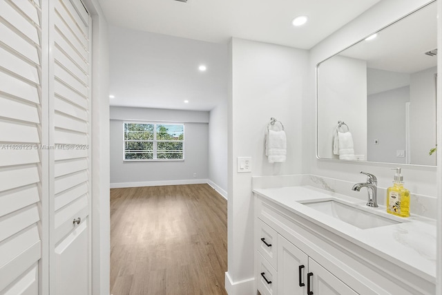 bathroom with hardwood / wood-style flooring and vanity