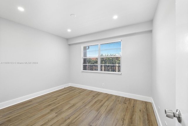 spare room with hardwood / wood-style flooring