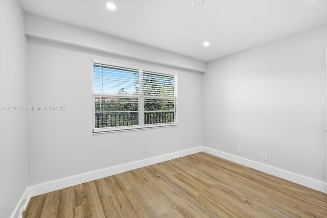 unfurnished room with wood-type flooring