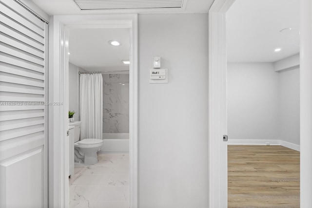 bathroom featuring vanity, hardwood / wood-style flooring, toilet, and curtained shower