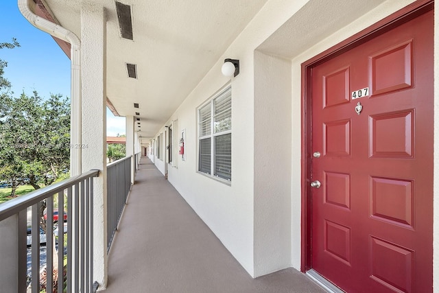 view of exterior entry with a balcony