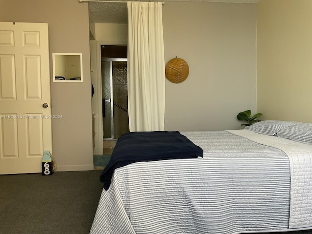 bedroom featuring a textured ceiling and carpet flooring