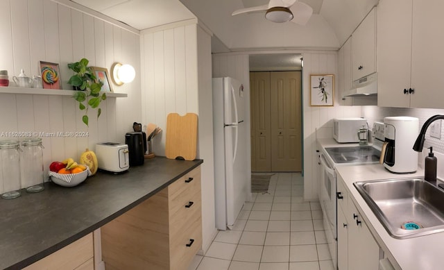 kitchen with white cabinetry, white appliances, sink, and light tile patterned flooring