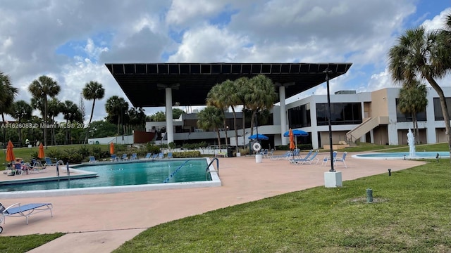 view of pool featuring a patio and a lawn