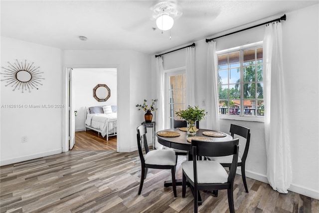 dining area with ceiling fan and hardwood / wood-style floors