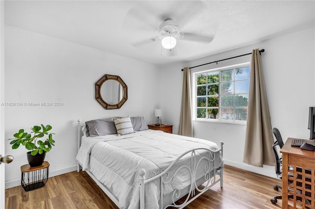 bedroom with ceiling fan and hardwood / wood-style floors