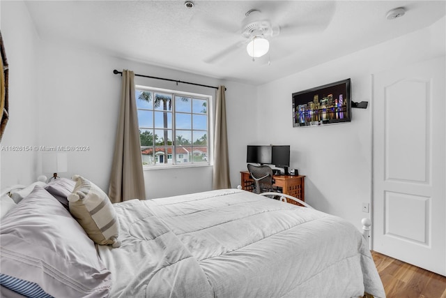 bedroom with wood-type flooring and ceiling fan