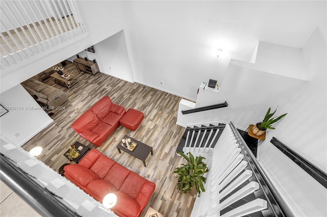 interior space with hardwood / wood-style flooring and a high ceiling