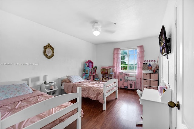 bedroom with dark hardwood / wood-style flooring and ceiling fan