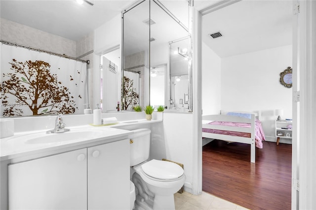 bathroom with vanity, toilet, and tile patterned flooring