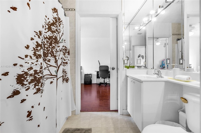 bathroom with vanity, tile patterned flooring, and toilet