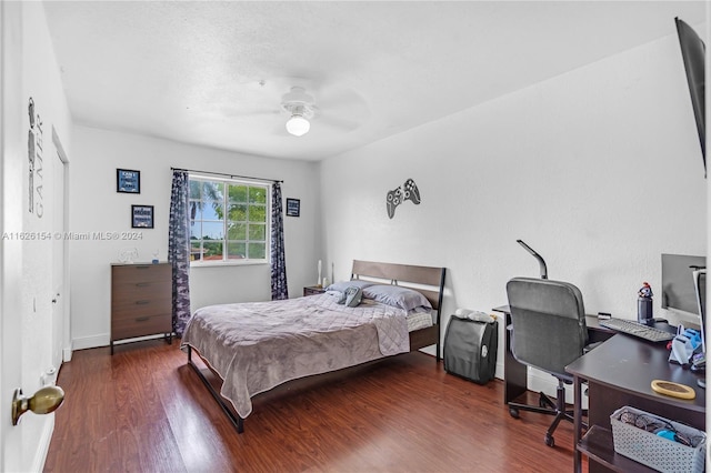 bedroom with dark hardwood / wood-style floors and ceiling fan