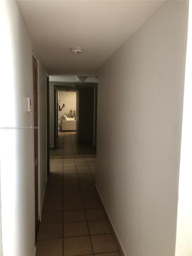 corridor with dark tile patterned flooring