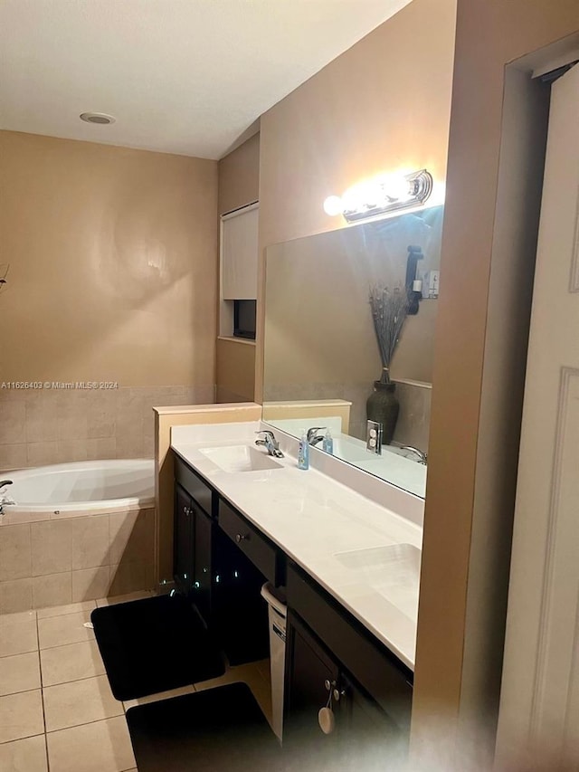 bathroom with a relaxing tiled tub, tile patterned flooring, and double sink vanity