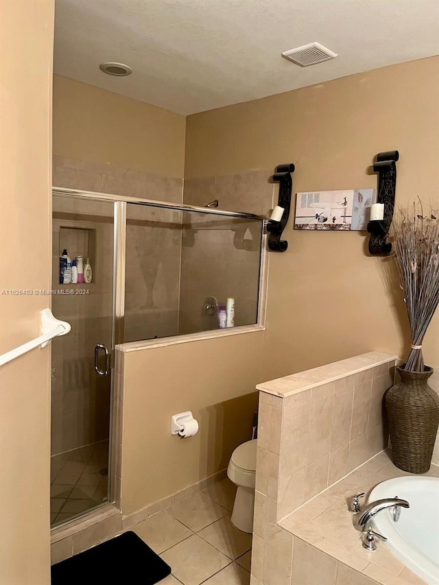 bathroom with independent shower and bath, tile patterned floors, and toilet