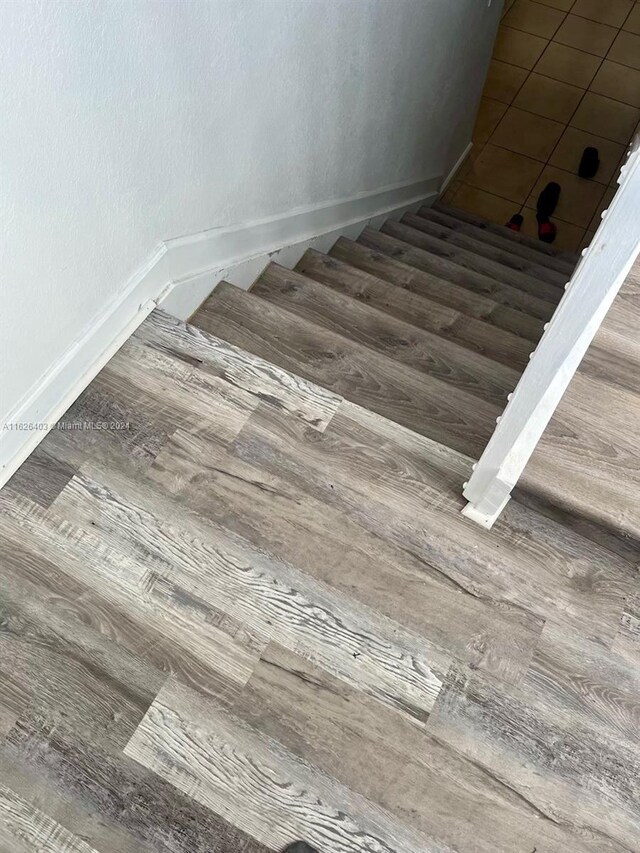 stairway featuring hardwood / wood-style floors