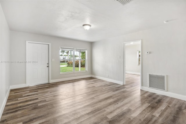 unfurnished room featuring hardwood / wood-style flooring