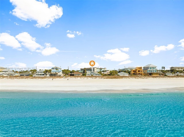 view of pool featuring a water view and a view of the beach