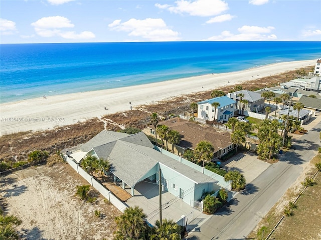 birds eye view of property with a view of the beach and a water view