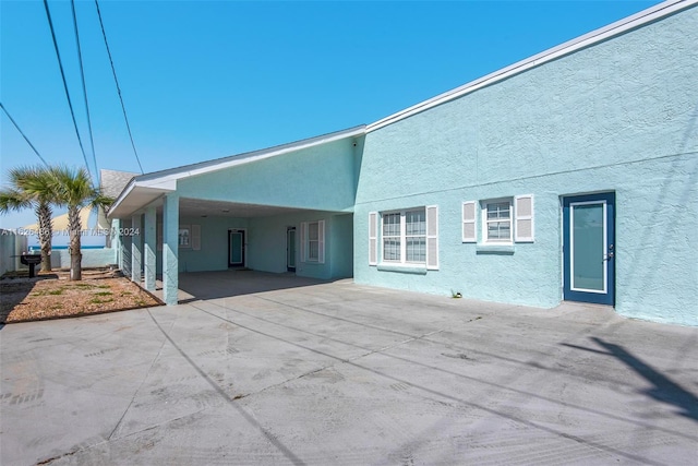 rear view of property with a carport