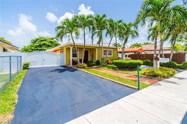 view of front of home featuring fence and a gate