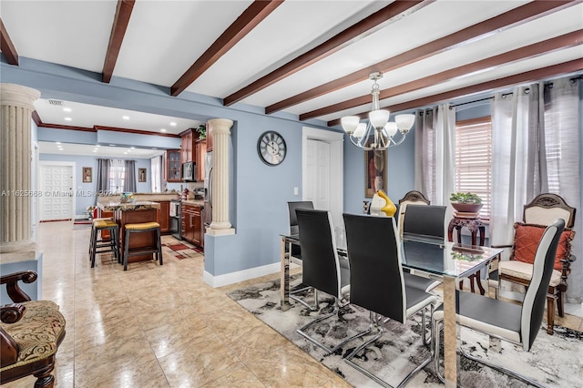 dining area featuring an inviting chandelier, a healthy amount of sunlight, baseboards, and ornate columns