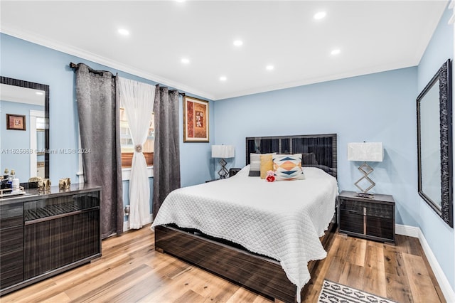 bedroom featuring recessed lighting, wood finished floors, baseboards, and ornamental molding