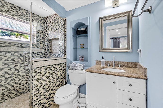 full bathroom with a shower stall, toilet, and vanity