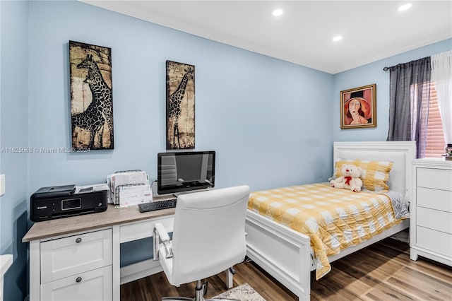 bedroom with recessed lighting and wood finished floors