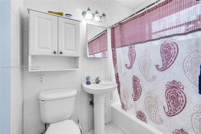 bathroom featuring toilet, decorative backsplash, shower / bath combination with curtain, tile walls, and a sink