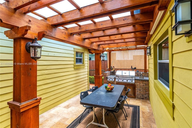 view of patio / terrace featuring outdoor dining space, fence, an outdoor kitchen, area for grilling, and a pergola