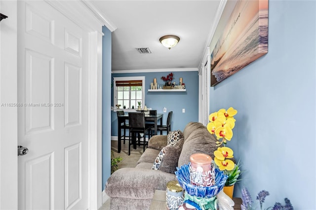 living room featuring visible vents and ornamental molding