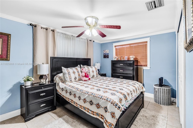 bedroom with light tile patterned floors, visible vents, and crown molding