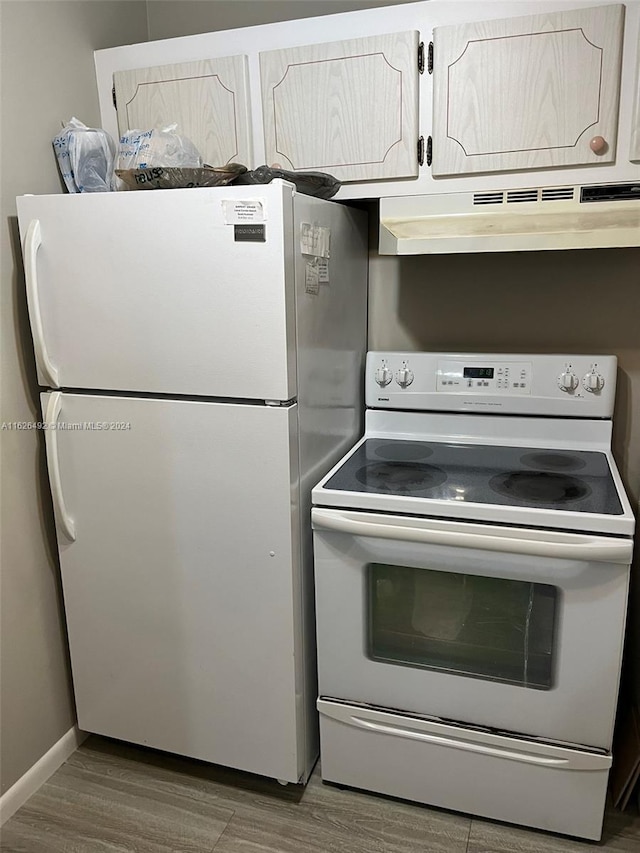 kitchen with white cabinetry, white appliances, and dark hardwood / wood-style floors