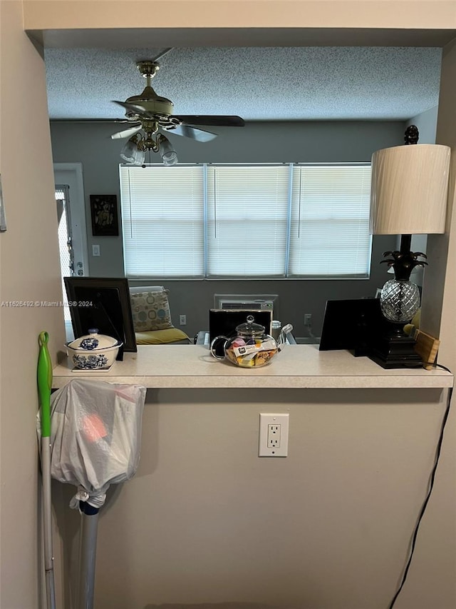 kitchen with a textured ceiling and ceiling fan