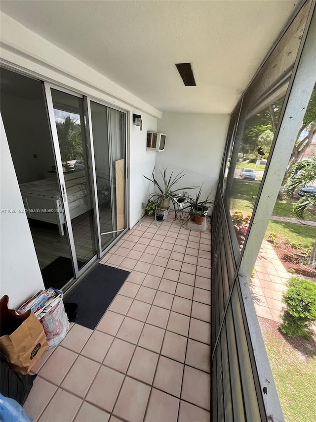 exterior space featuring a balcony and a wall mounted AC