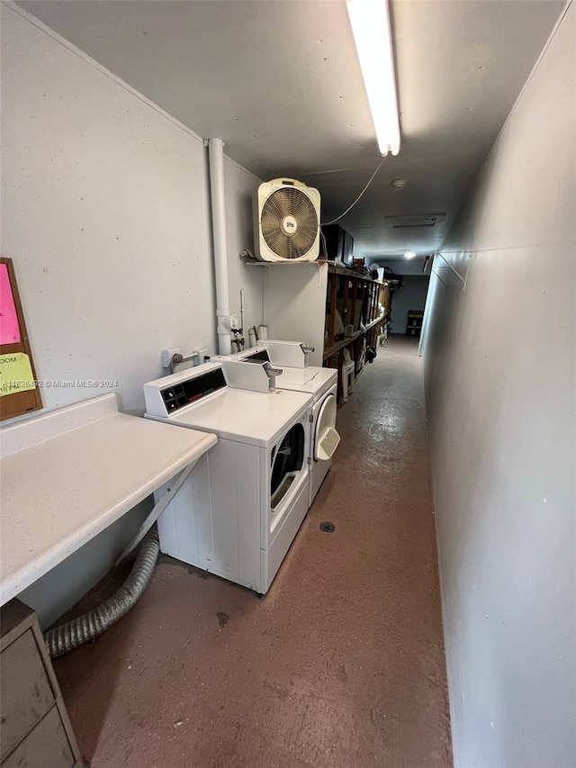 clothes washing area featuring independent washer and dryer