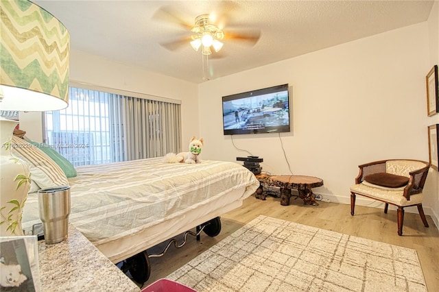 bedroom featuring hardwood / wood-style flooring and ceiling fan