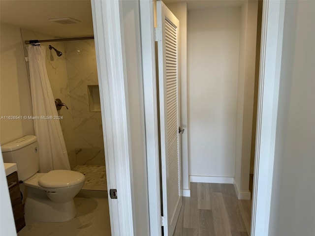 bathroom with toilet, hardwood / wood-style floors, vanity, and a shower with shower curtain