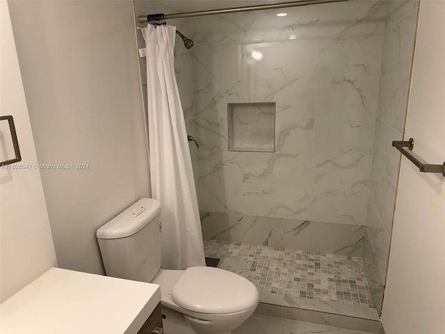 bathroom with walk in shower, vanity, and toilet