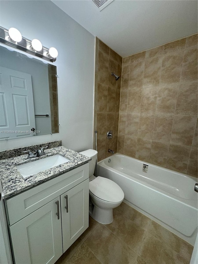 full bathroom featuring vanity, toilet, and tiled shower / bath