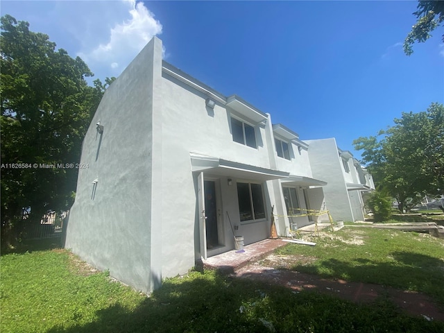 rear view of property with a yard