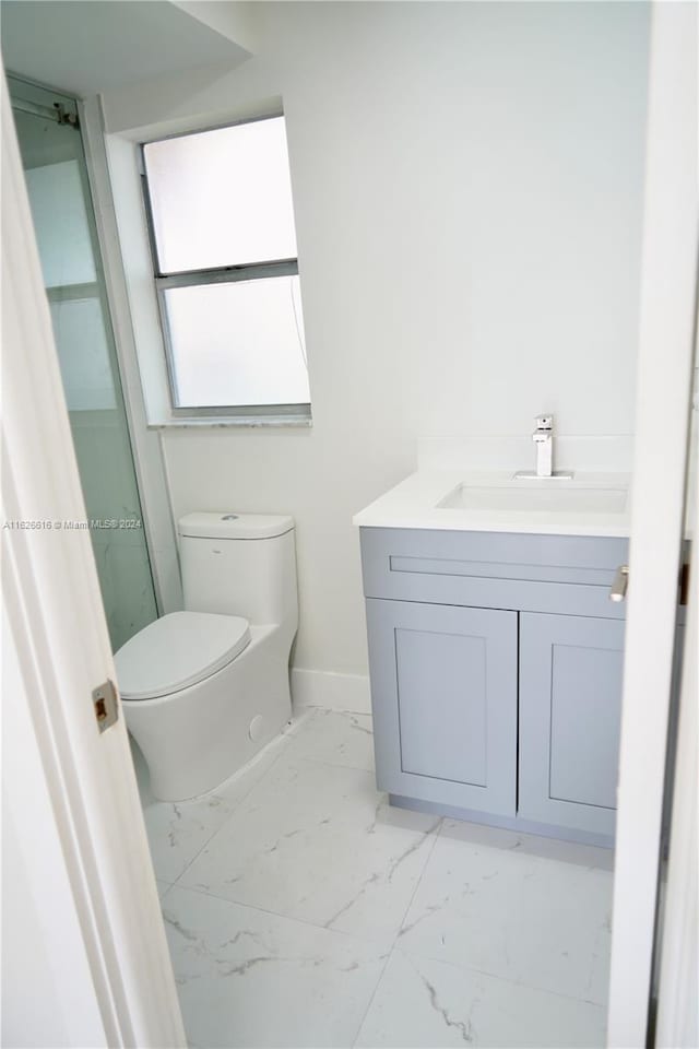 bathroom with vanity, tile patterned flooring, and toilet